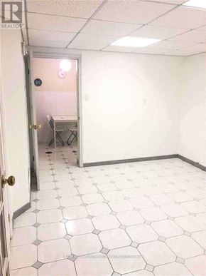Toronto (Kensington-Chinatown) apartment for rent - A room with white tile flooring and a door.