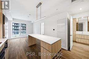 Toronto (Niagara) condo for rent - A modern kitchen with a large island in the middle.