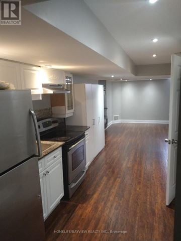 Bradford West Gwillimbury (Bradford) apartment for rent - A kitchen with white cabinets and a stainless steel refrigerator.