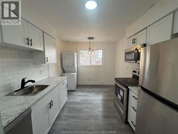 Windsor apartment for rent - A kitchen with white cabinets and a stainless steel refrigerator.
