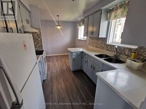 Toronto (Tam O'shanter-Sullivan) apartment for rent - A kitchen with a white fridge and wooden floors.