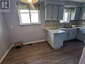Toronto (Tam O'shanter-Sullivan) apartment for rent - A kitchen with wooden floors and white cabinets.
