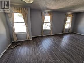 Toronto (Tam O'shanter-Sullivan) apartment for rent - A room with wooden flooring and two windows with curtains.