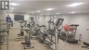 Markham (Thornhill) condo for rent - A gym with a variety of equipment including treadmills, weights, and exercise machines.