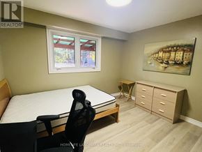 Toronto (Highland Creek) apartment for rent - A bedroom with a bed, chair, and a painting on the wall.