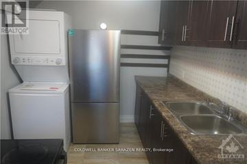 Ottawa apartment for rent - A kitchen with a stainless steel refrigerator and a white refrigerator freezer.