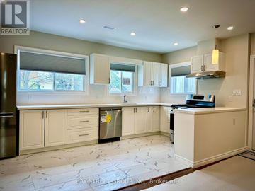 Hamilton (Hamilton Beach) apartment for rent - A kitchen with white cabinets and a marble floor.