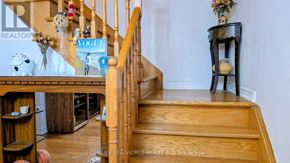 Vaughan (Sonoma Heights) apartment for rent - A wooden staircase with a magazine on the railing and a vase of flowers on the landing.