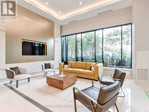Mississauga (Hurontario) condo for rent - A living room with a large couch, a television, and a coffee table.