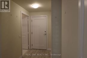Mississauga (Hurontario) condo for rent - A hallway with a door and a Real One Realty Inc. sign.