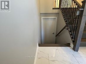 Toronto (Pleasant View) apartment for rent - A white door is in a hallway with a staircase.