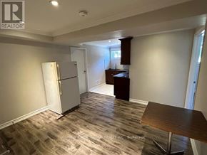 Toronto (Pleasant View) apartment for rent - A kitchen with a refrigerator, table, and cabinets.