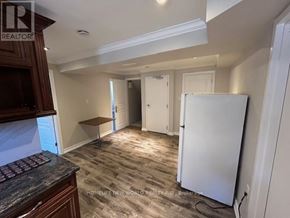 Toronto (Pleasant View) apartment for rent - A kitchen area with a refrigerator, cabinets, and a countertop.
