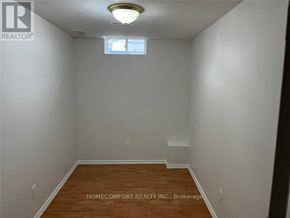 Markham (Cedarwood) apartment for rent - A room with a wooden floor and white walls, with a window and a light fixture on the ceiling.