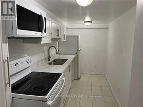 Markham (Cedarwood) apartment for rent - A white kitchen with a stove, microwave, and oven.