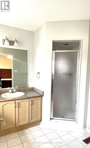 Markham (Berczy) apartment for rent - A bathroom with a sink, mirror, and shower.