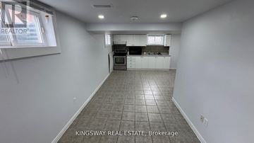 Richmond Hill (Oak Ridges Lake Wilcox) apartment for rent - A kitchen area with white cabinets and a tiled floor.