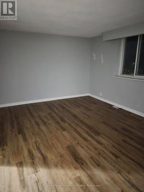 Minto multi-family for rent - A room with wooden flooring and a window.