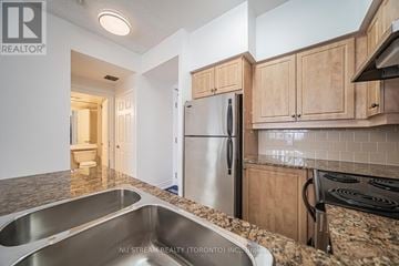 Toronto (Lawrence Park South) condo for rent - A kitchen with a stainless steel refrigerator and a granite countertop.