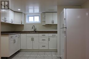 Richmond Hill (Crosby) apartment for rent - A kitchen with white cabinets and a refrigerator.