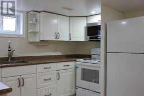Richmond Hill (Crosby) apartment for rent - A kitchen with white cabinets and appliances.