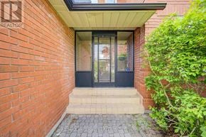 Toronto (West Hill) apartment for rent - A red brick wall with a black door and a glass window.