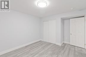 Ajax (Central East) apartment for rent - A room with white walls and a wooden floor.