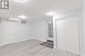 Ajax (Central East) apartment for rent - A white room with a door and a window.