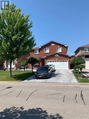Markham (Middlefield) apartment for rent - A black car is parked in front of a red brick house.
