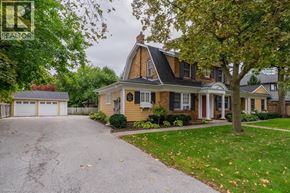 Burlington apartment for rent - A house with a driveway and a tree in front.