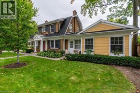 Burlington apartment for rent - A house with a well-maintained lawn and a tree in front.