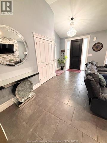 Windsor apartment for rent - A living room with a grey couch and a mirror on the wall.