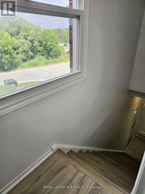 Aurora (Hills Of St Andrew) multi-family for rent - A room with a window overlooking a street.