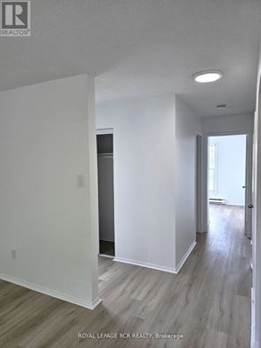 Aurora (Hills Of St Andrew) multi-family for rent - A white room with a doorway leading to another room.