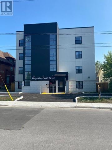 St. Thomas condo for rent - A modern building with a glass entrance and a sign that reads "Six-Nine Curts Street".