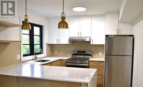 Ottawa apartment for rent - A kitchen with a white countertop and stainless steel appliances.