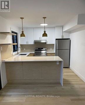 Ottawa apartment for rent - A modern kitchen with a large island and stainless steel appliances.
