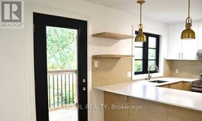 Ottawa apartment for rent - A kitchen with a white countertop and a black door.
