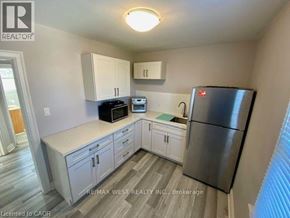 Hamilton apartment for rent - A kitchen with a refrigerator, microwave, and oven.