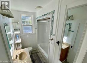 Hamilton apartment for rent - A bathroom with a toilet, sink, and bathtub.