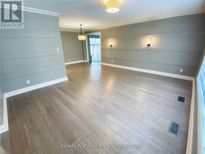 Toronto (Bayview Village) apartment for rent - A spacious room with wood flooring and a ceiling light.