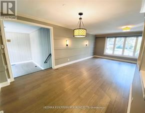 Toronto (Bayview Village) apartment for rent - A well-lit room with wooden flooring and a chandelier hanging from the ceiling.