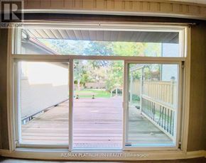 Toronto (Bayview Village) apartment for rent - A view from a window looking out to a deck and a backyard.