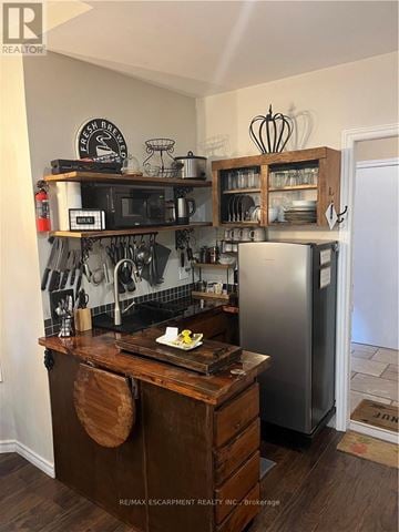 Hamilton (Dundas) apartment for rent - A kitchen with a wooden counter and a stainless steel refrigerator.