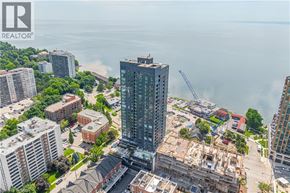 Burlington condo for rent - A cityscape with a large body of water in the background and a building under construction in the foreground.