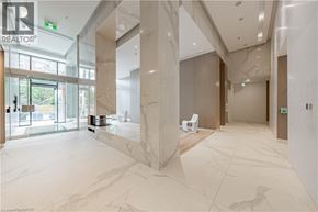 Burlington condo for rent - A marble hallway with a glass door leading outside.