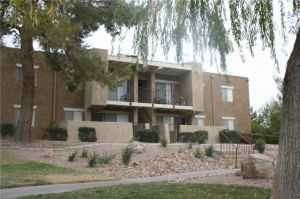 Boulder City apartment for rent - A brown building with a tree in front.