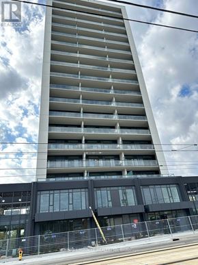 Kitchener condo for rent - A tall building with a glass facade is under construction.