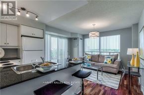 Toronto (Bayview Village) condo for rent - A modern kitchen and living room with a dining table set for two.