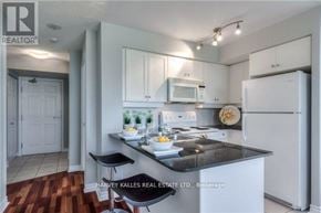 Toronto (Bayview Village) condo for rent - A kitchen with a refrigerator, microwave, and stove top oven.